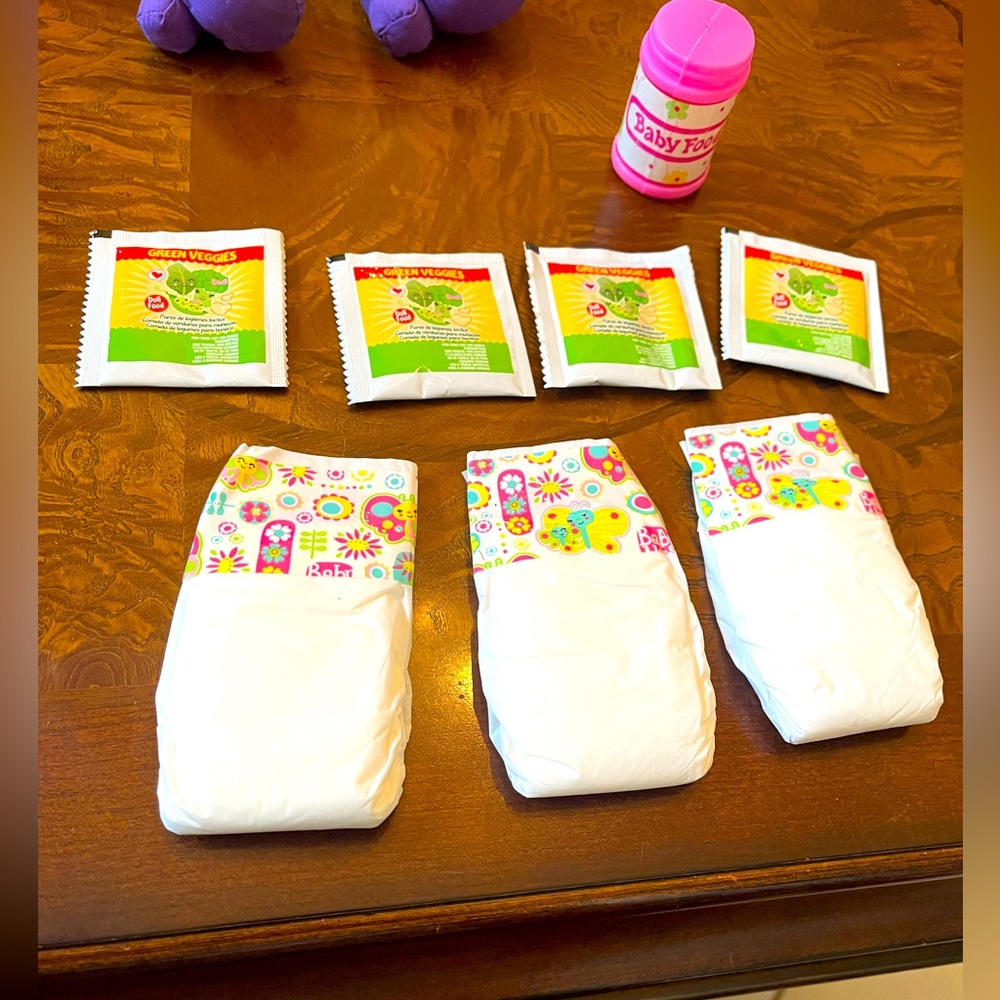 Vintage baby alive bundle, includes three diapers, four food, one pretend.